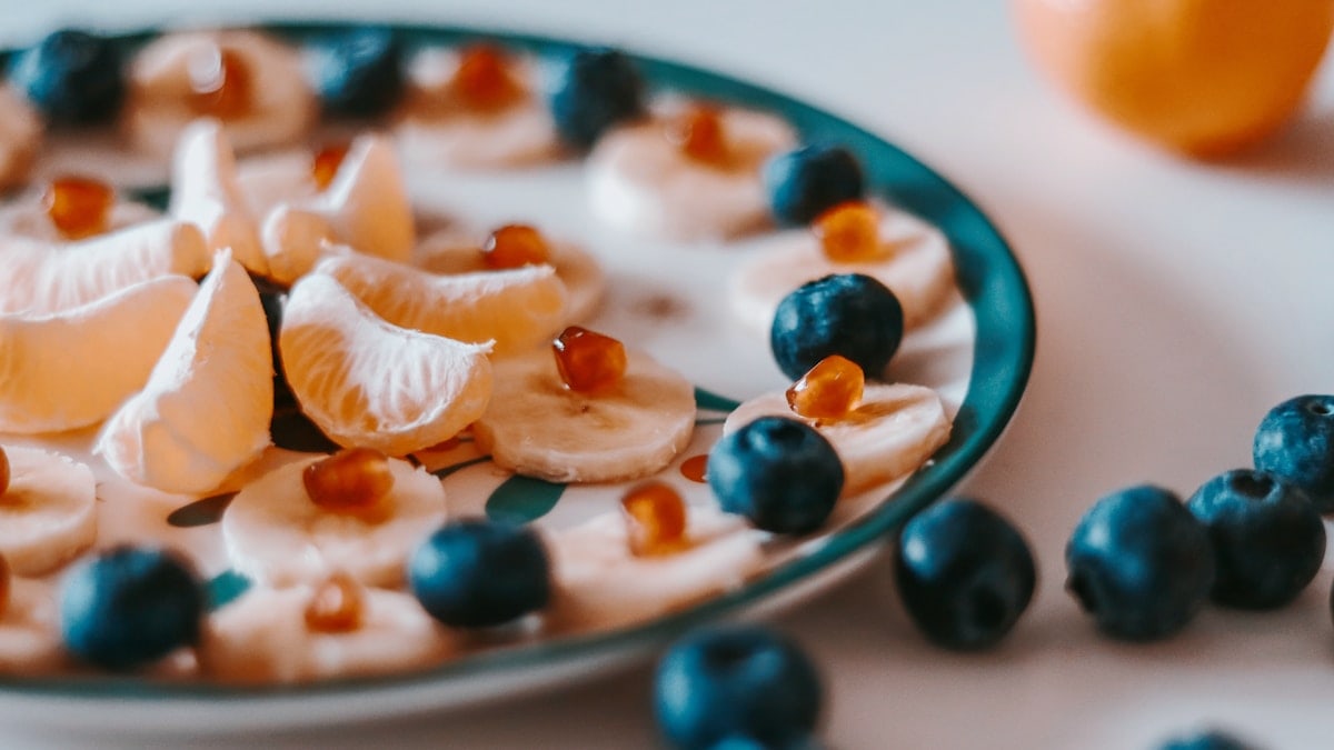 sliced of orange fruit on white and blue ceramic plate